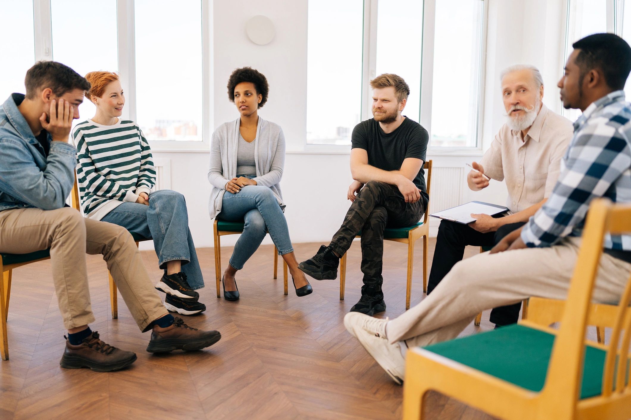 People seated together in a reflective group setting