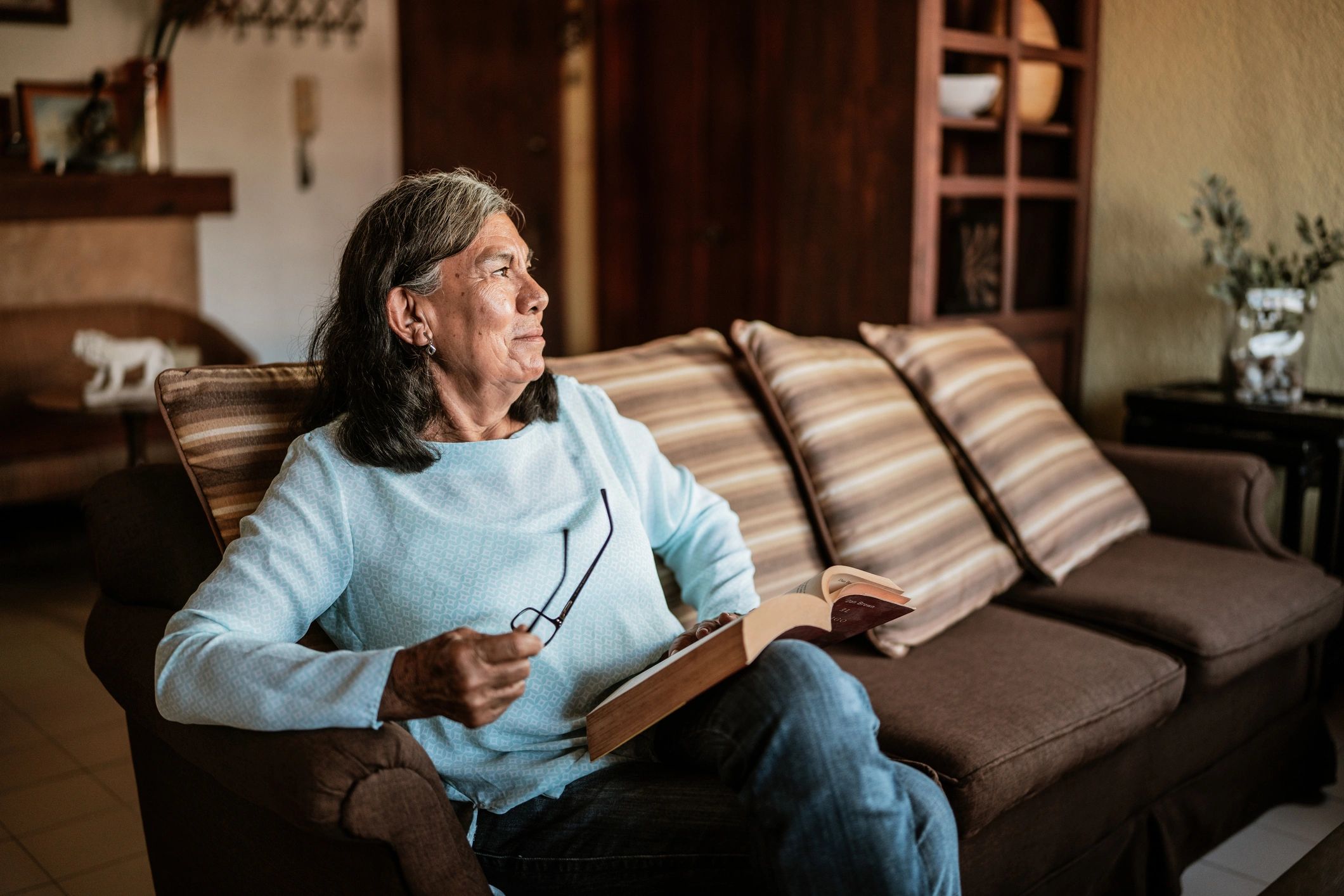 Woman reflecting thoughtfully at home